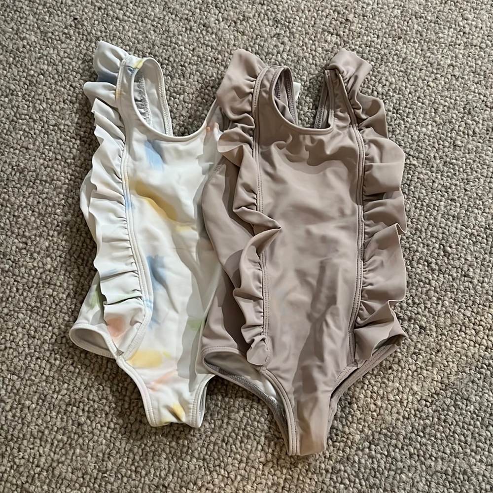 Minnow. Size 1 ruffle one piece. 2 styles